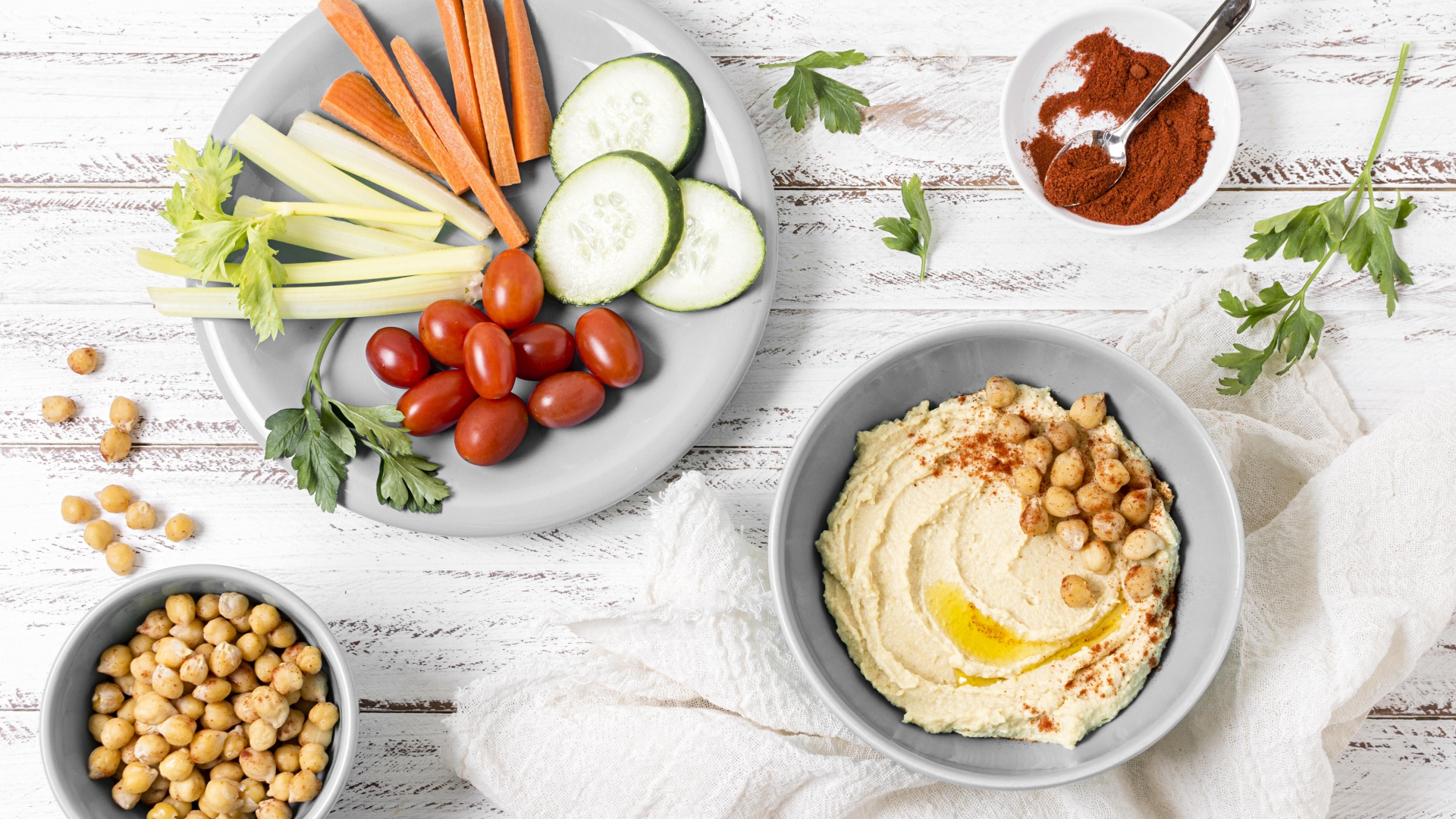 Fresh Veggies with Hummus A plate of sliced vegetables like carrots and cucumbers served with a bowl of hummus.