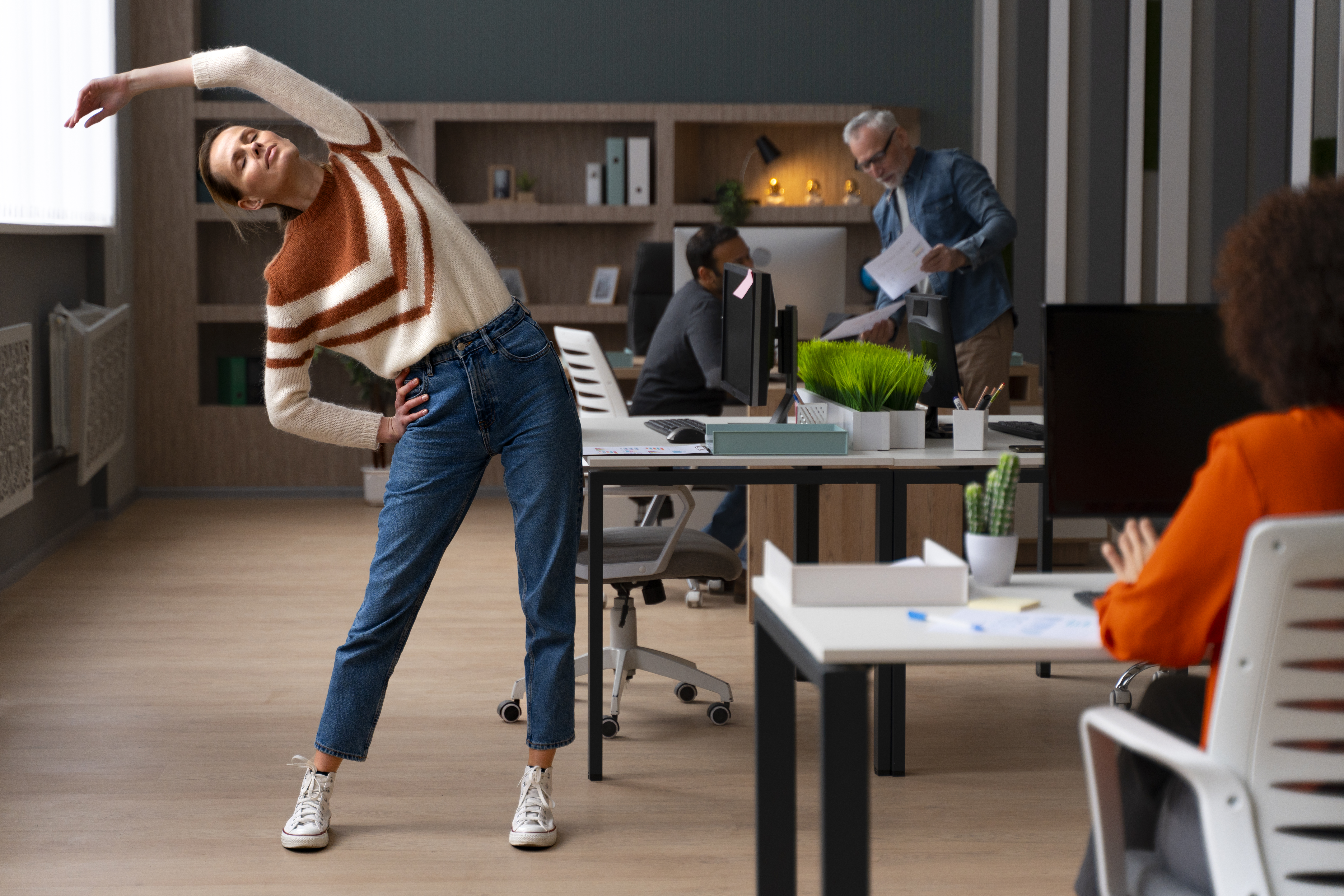 Move Your Body, Clear Your Mind Person stretching at their desk during a work break